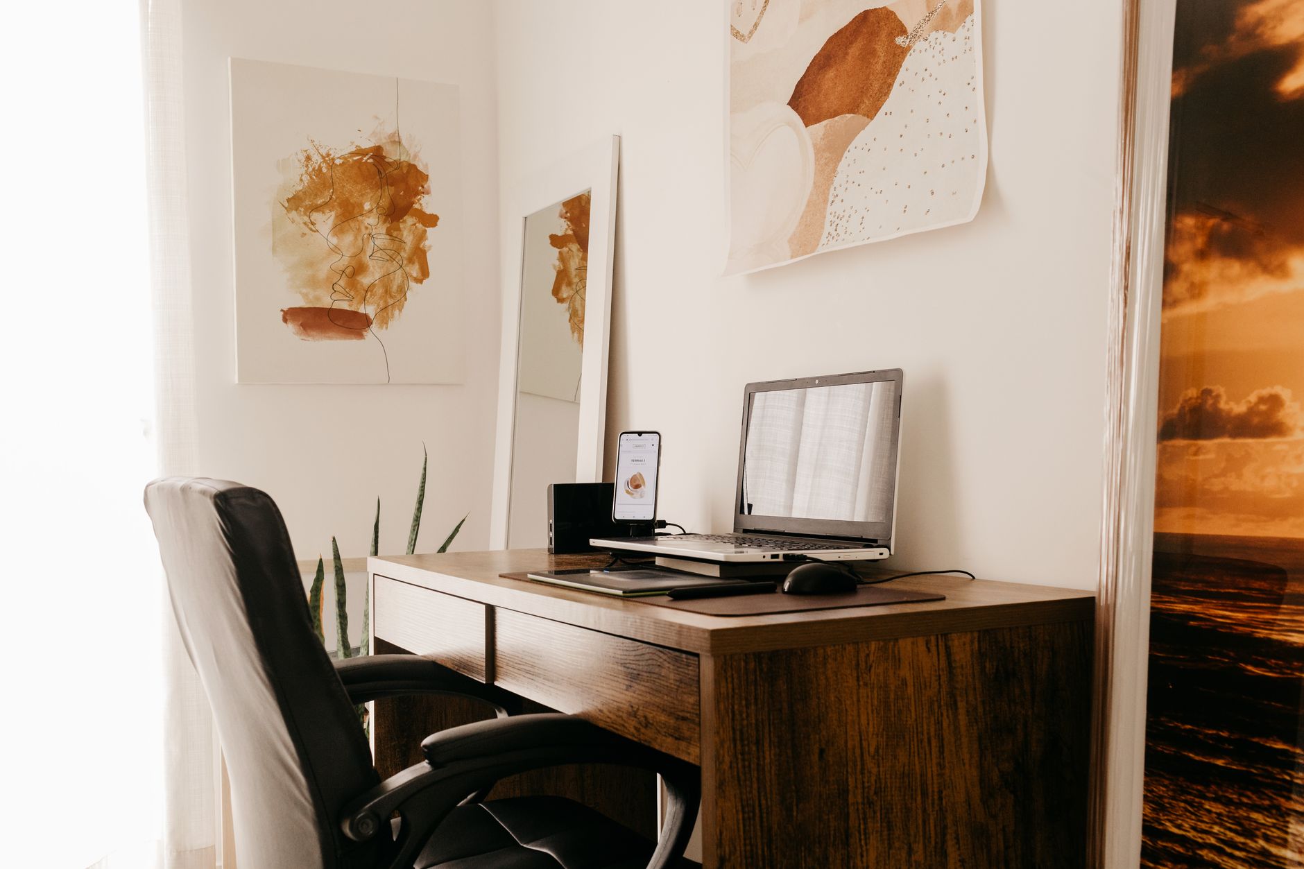 Espace de travail confortable avec ordinateur portable et appareils connectés, dans un appartement lumineux en journée.